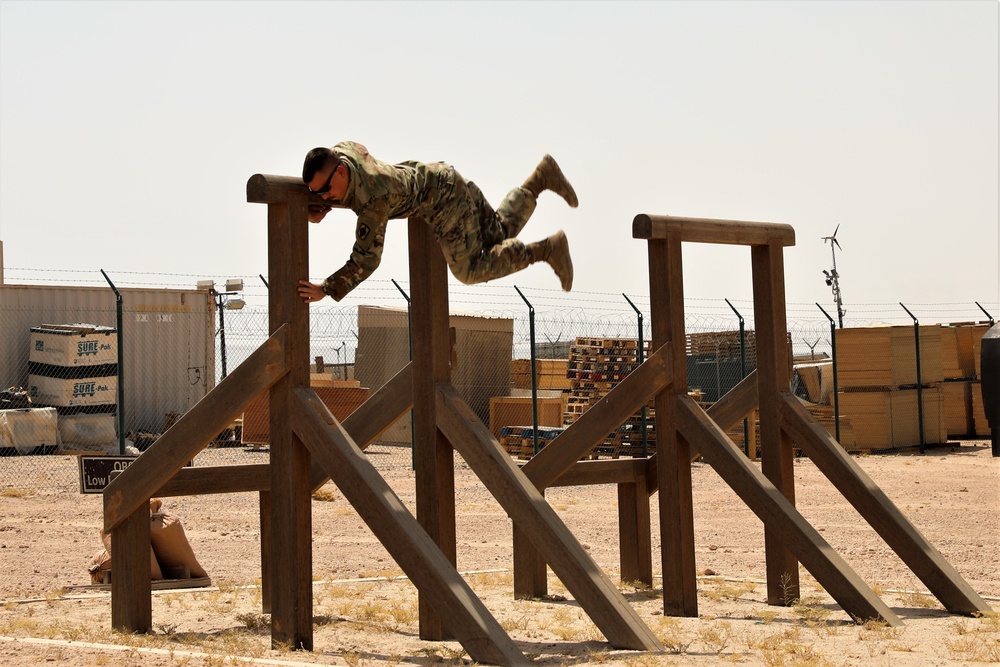 Spc. Christopher Dame completes the obstacle course during the Task Force Spartan best warrior competition in Kuwait