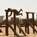 Spc. Christopher Dame completes the obstacle course during the Task Force Spartan best warrior competition in Kuwait