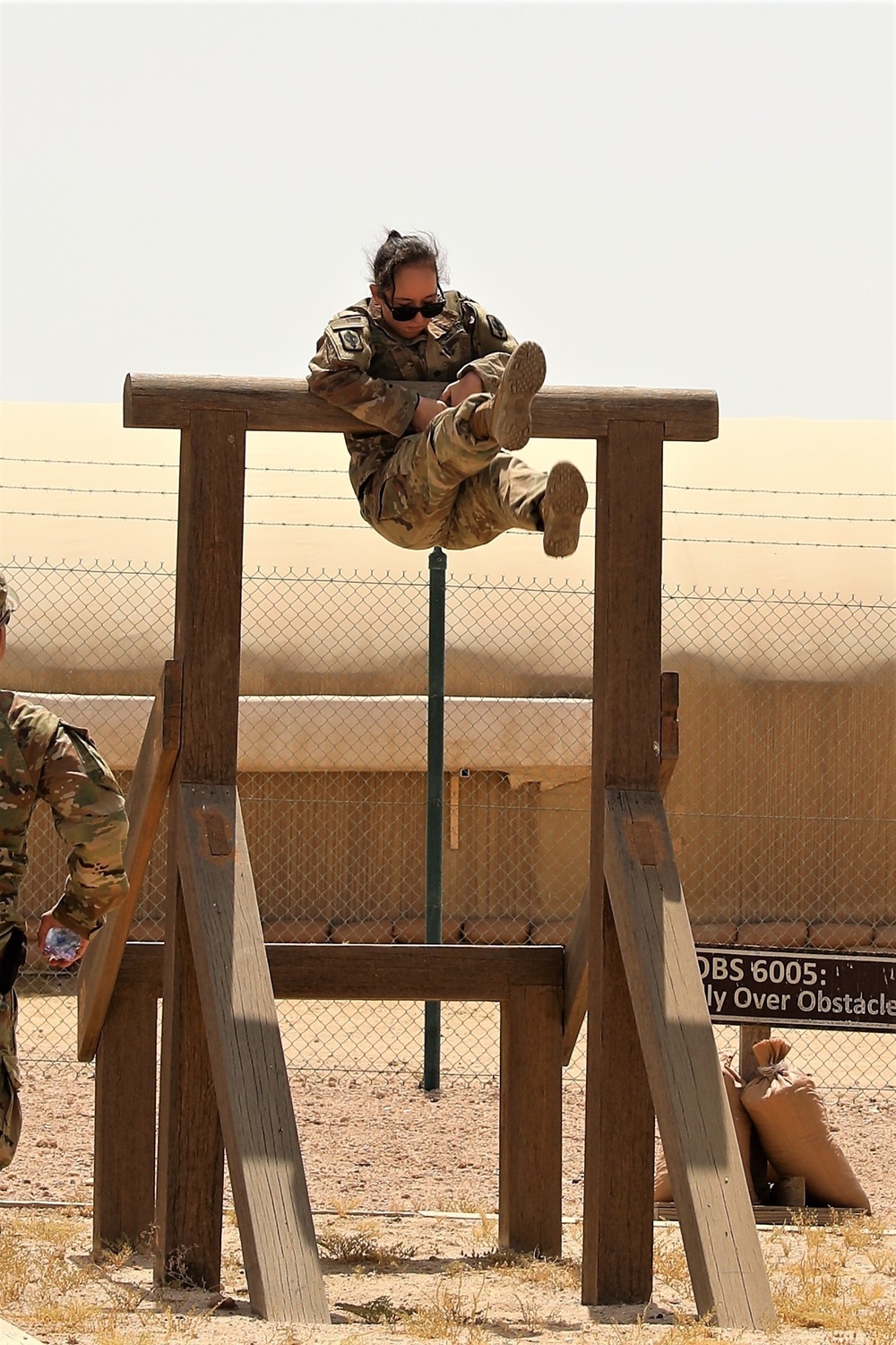 Spc. Grace Tsen competes in the obstacle course during the Task Force Spartan best warrior competition in Kuwait