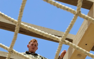 Sgt. Erik Wold completes the obstacle course during the Task Force Spartan best warrior competition in Kuwait