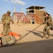 Spc. Grace Tsen completes a medical evacuation test during the Task Force Spartan best warrior competition in Kuwait