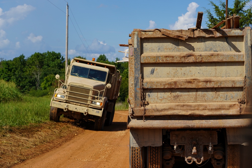 National Guard Trucks Transporting Debris To Landfill