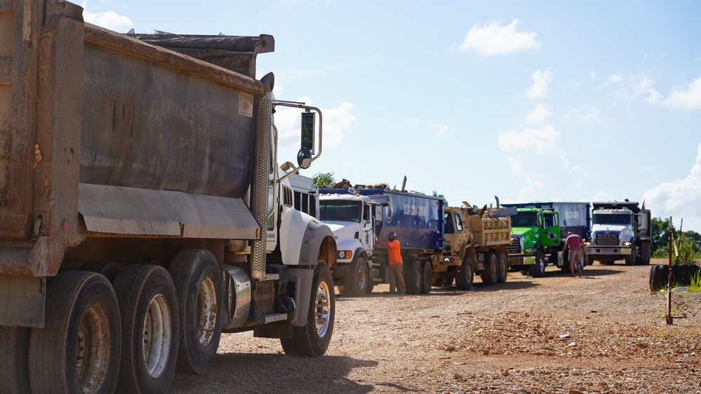 Truck With Debris Lined-Up to Enter Landfill