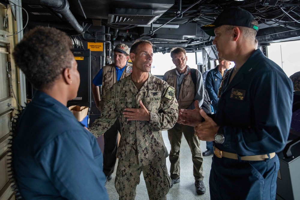 Rear Adm. Davids Speaks with Capt. Eric Kellum on the Bridge Of USS Arlington