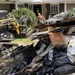 Southern Baptist Disaster Relief Volunteers Pile Debris at Curb