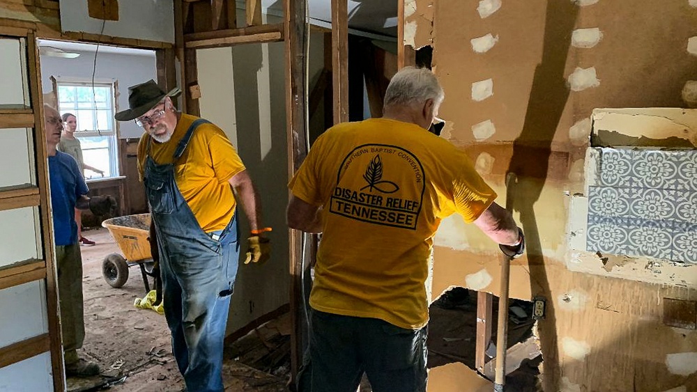 Volunteers Break Down Damaged Walls