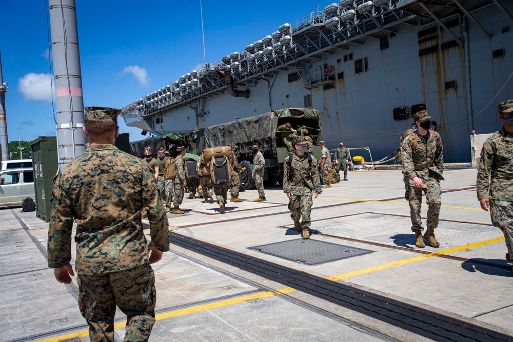 US Marines and Sailors debark USS America