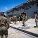 US Marines and Sailors debark USS America