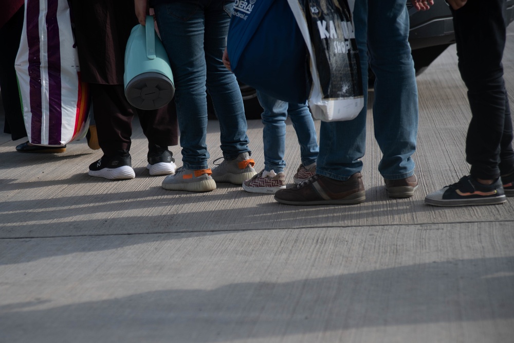 Evacuees from Afghanistan prepare to board