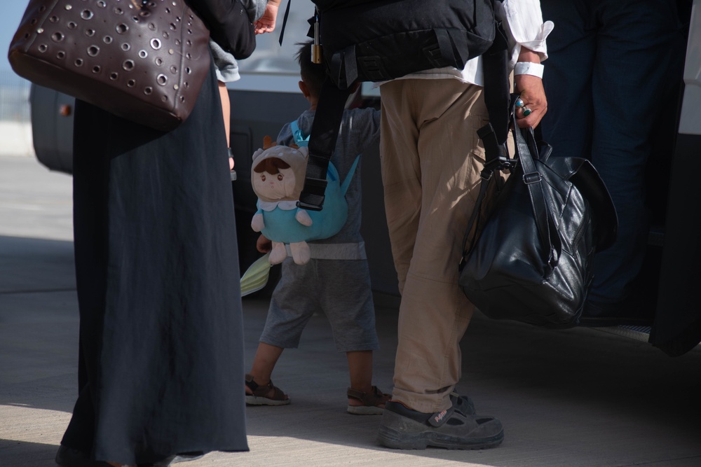Evacuees from Afghanistan prepare to board