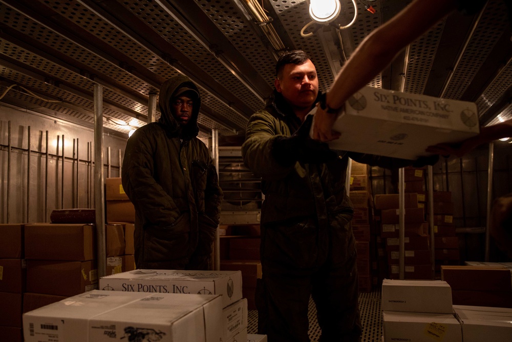 USS Arlington Sailor Organizes Stores in Freezer During a Replenishment-At-Sea