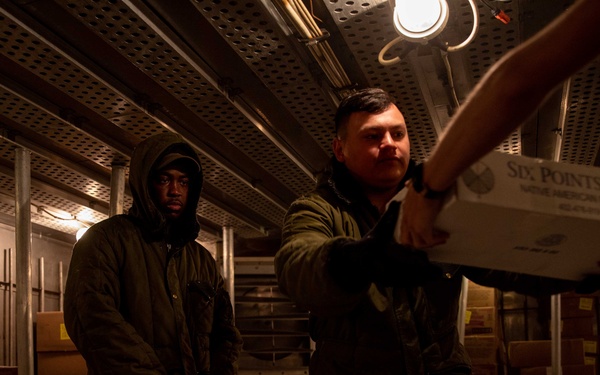 USS Arlington Sailor Organizes Stores in Freezer During a Replenishment-At-Sea
