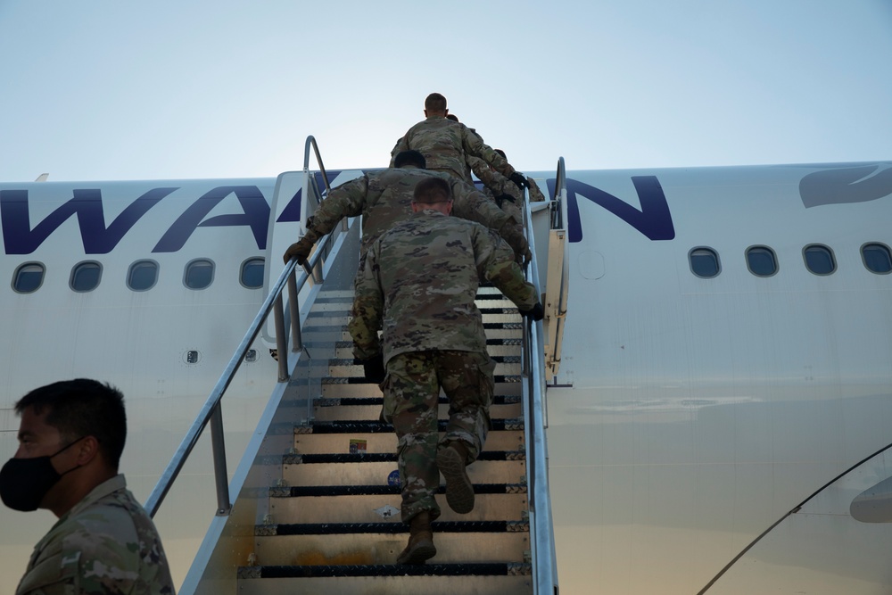 1st Armored Division soldiers help arriving Afghan evacuees