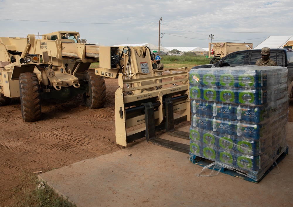 Soldiers deliver water to Afghan evacuees