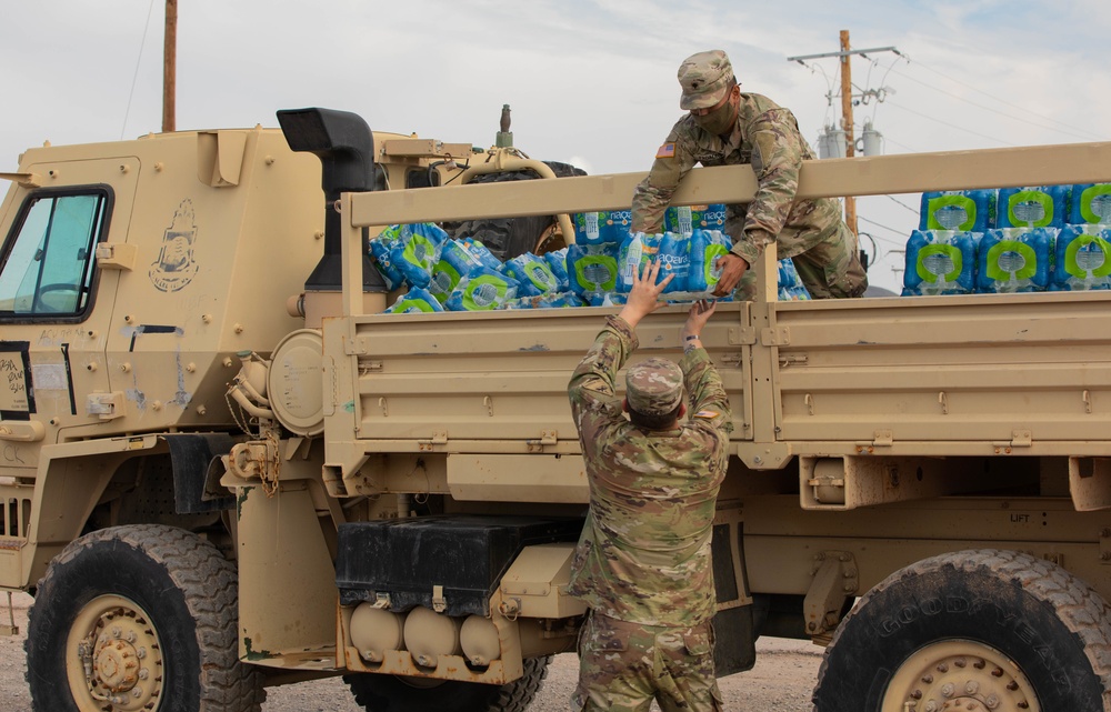 Soldiers deliver water to Afghan evacuees