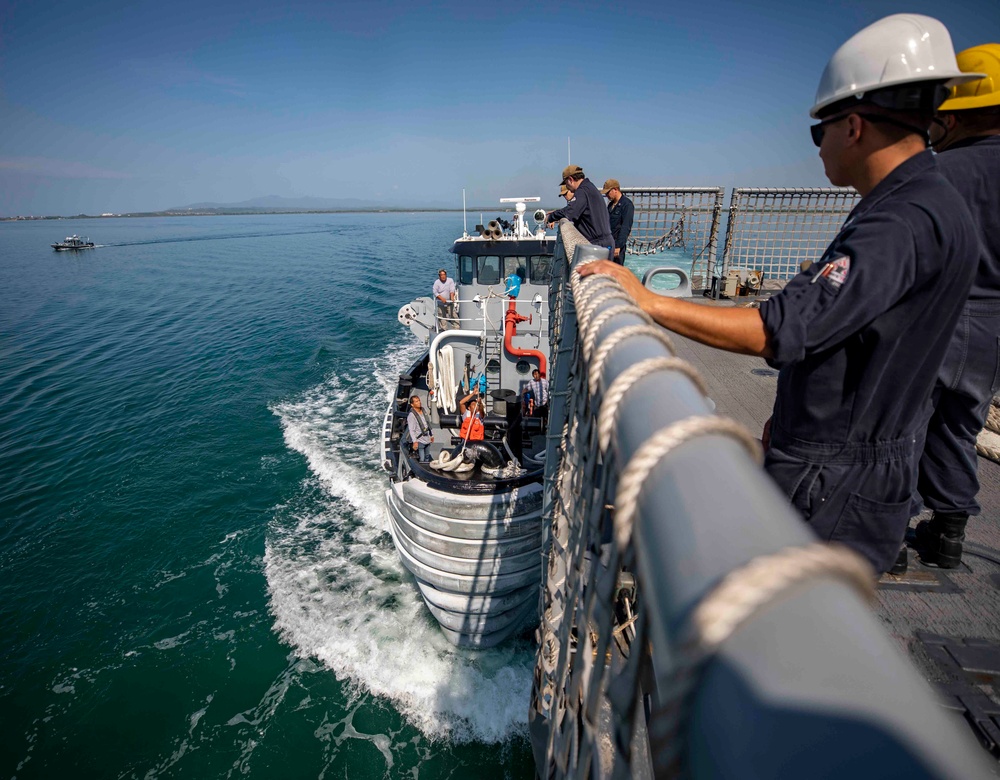 USS Billings Sailor Oversees The Arrival of a Tugboat During Sea and Anchor Detail