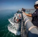 USS Billings Sailor Oversees The Arrival of a Tugboat During Sea and Anchor Detail