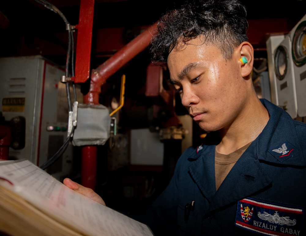 EM3 Rizaldy Gabay Conducts Preventive Maintenance in the Engine Room Aboard the USS Barry