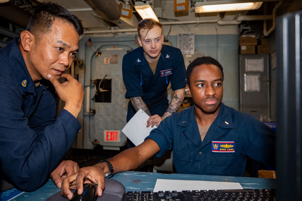 LT JG Mario Evans receives Engineering Watch Training from GSMC Dexter Jay Anis aboard the USS Barry