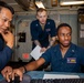 LT JG Mario Evans receives Engineering Watch Training from GSMC Dexter Jay Anis aboard the USS Barry