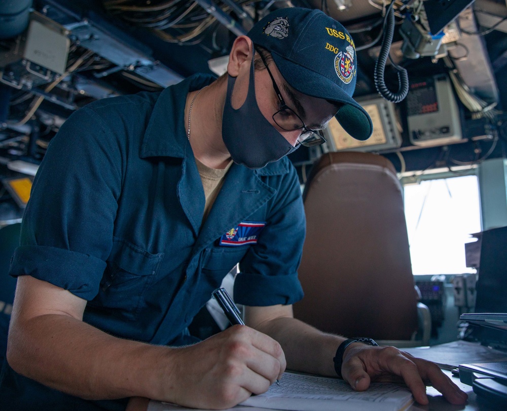QMSN Dade Geier Prepares a Position Report in the Pilot House aboard the USS Barry