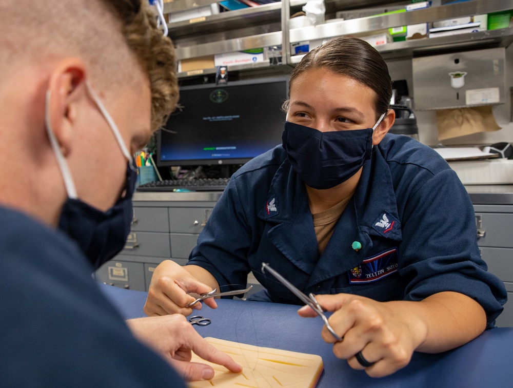 HM3 Zeltzin Soto and HM3 Bryce Davenport conduct Suture Training aboard the USS Barry
