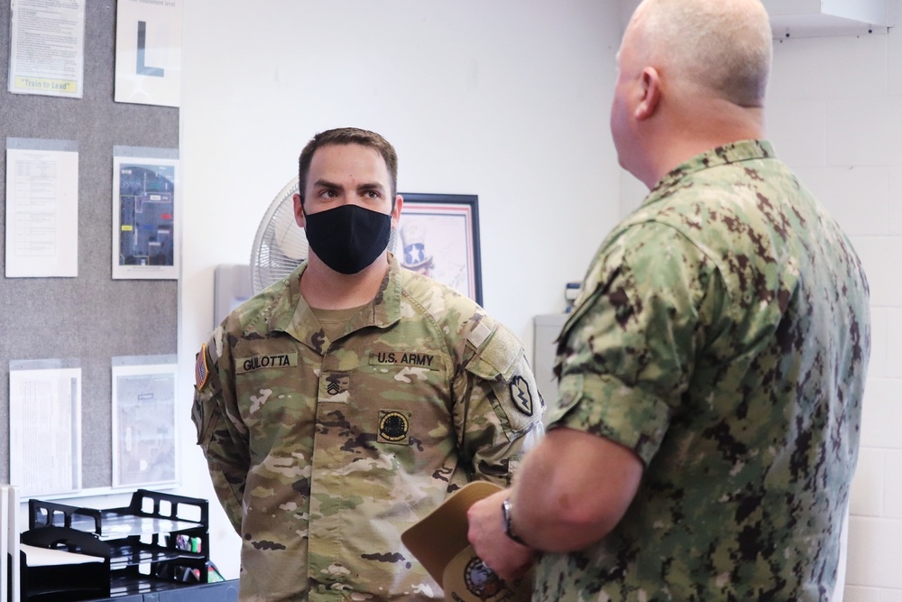 Fleet Master Chief James Honea speaks with Staff Sgt. Ryan Gulotta about the Basic Leader Course