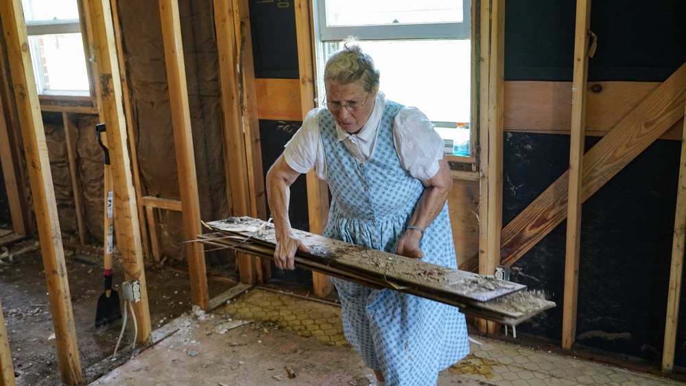 Christian Aid Ministries Volunteer Removing Debris