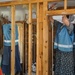 Volunteers Remove Damaged Walls in Flooded Home