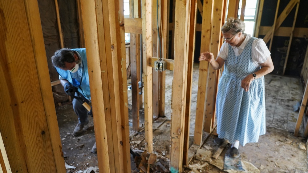 Ripping Up Damaged Floor in Flooded House