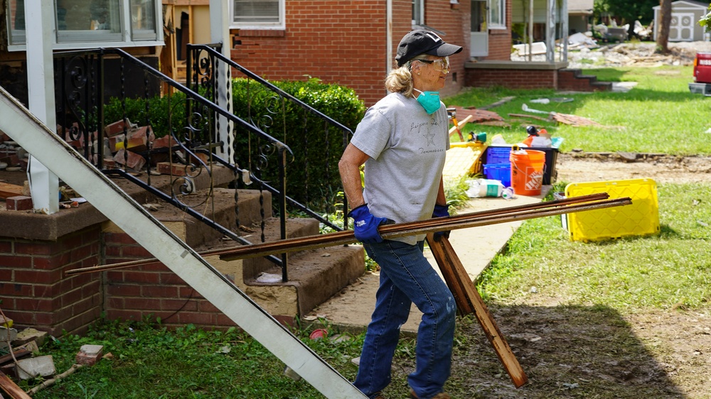 Volunteer Carrying Out Debris