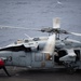 USS Carl Vinson (CVN 70) Aviation Ordinancemen Check The Weapons Systems Of An MH-60S