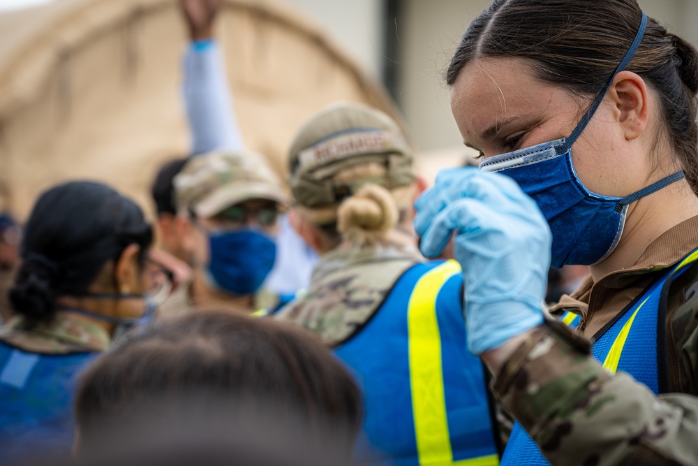 Augmentees and Security Forces interact with evacuees