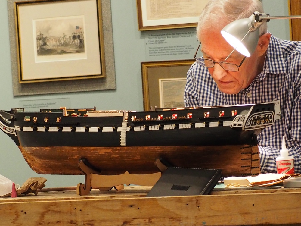 Volunteer model ship builder at Naval Museum