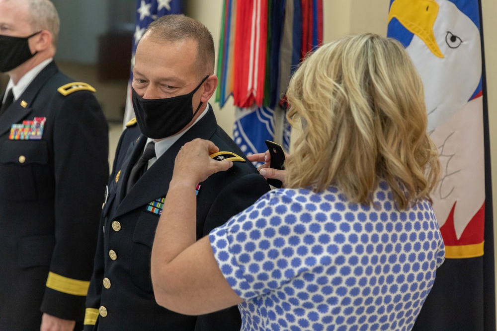 Cyndy Roache attaches a new rank to Maj. Gen. Michael D. Roache