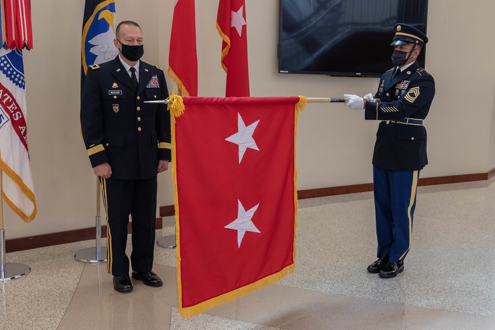 Master Sgt. Hector Galindez presents Maj. Gen. Michael D. Roache two star flag