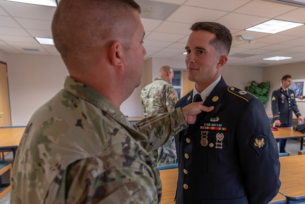 Master Sgt. Derek Fontaine inspects Spc. Nicholas Kyne's 2021 Army Reserve Soldier of the Year, uniform