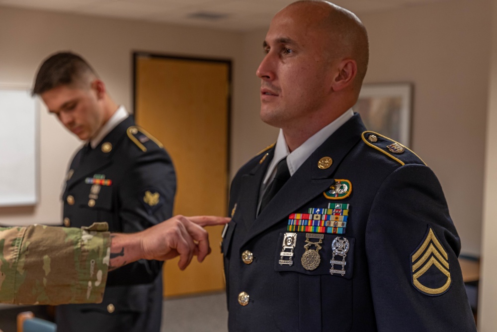 Staff Sgt. Jonathan Chacon has his uniform inspected
