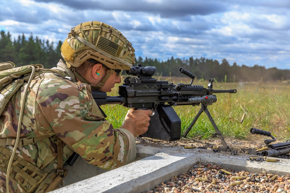 Sgt. Ryan Rudolph fires an M249 machine gun
