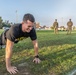 Spc. Nicholas Kyne performs a hand release push-up