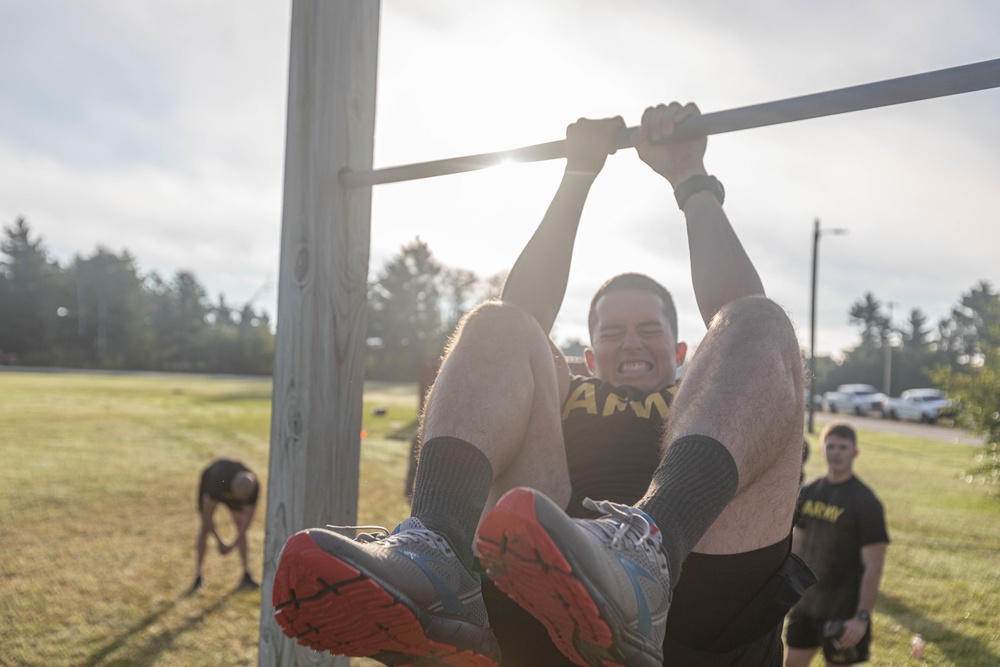 Spc. Nicholas Kyne completes a leg tuck