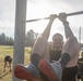 Spc. Nicholas Kyne completes a leg tuck