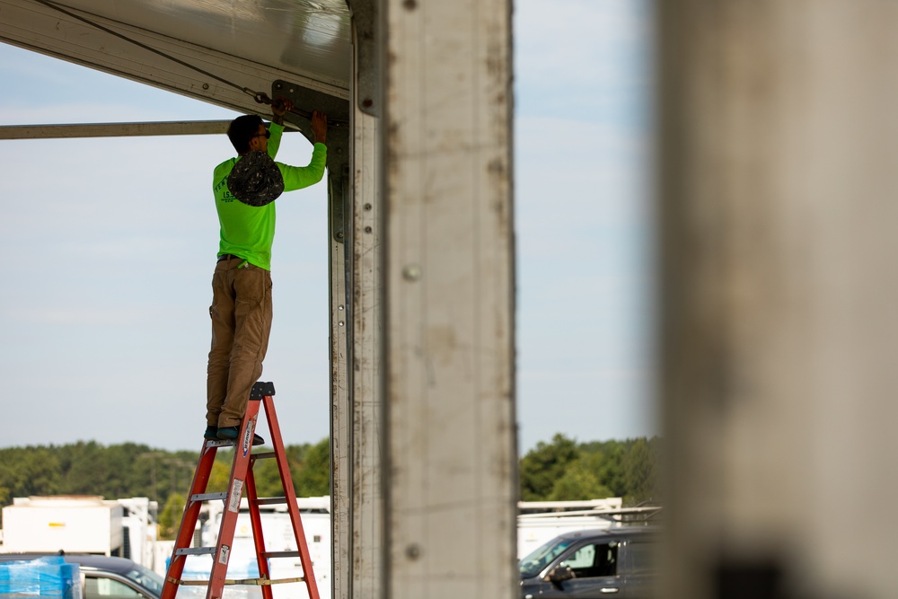 Contract Worker Attaches Support Cables for New Residential Buildings at Fort Pickett, Virginia.