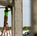 Contract Worker Attaches Support Cables for New Residential Buildings at Fort Pickett, Virginia.