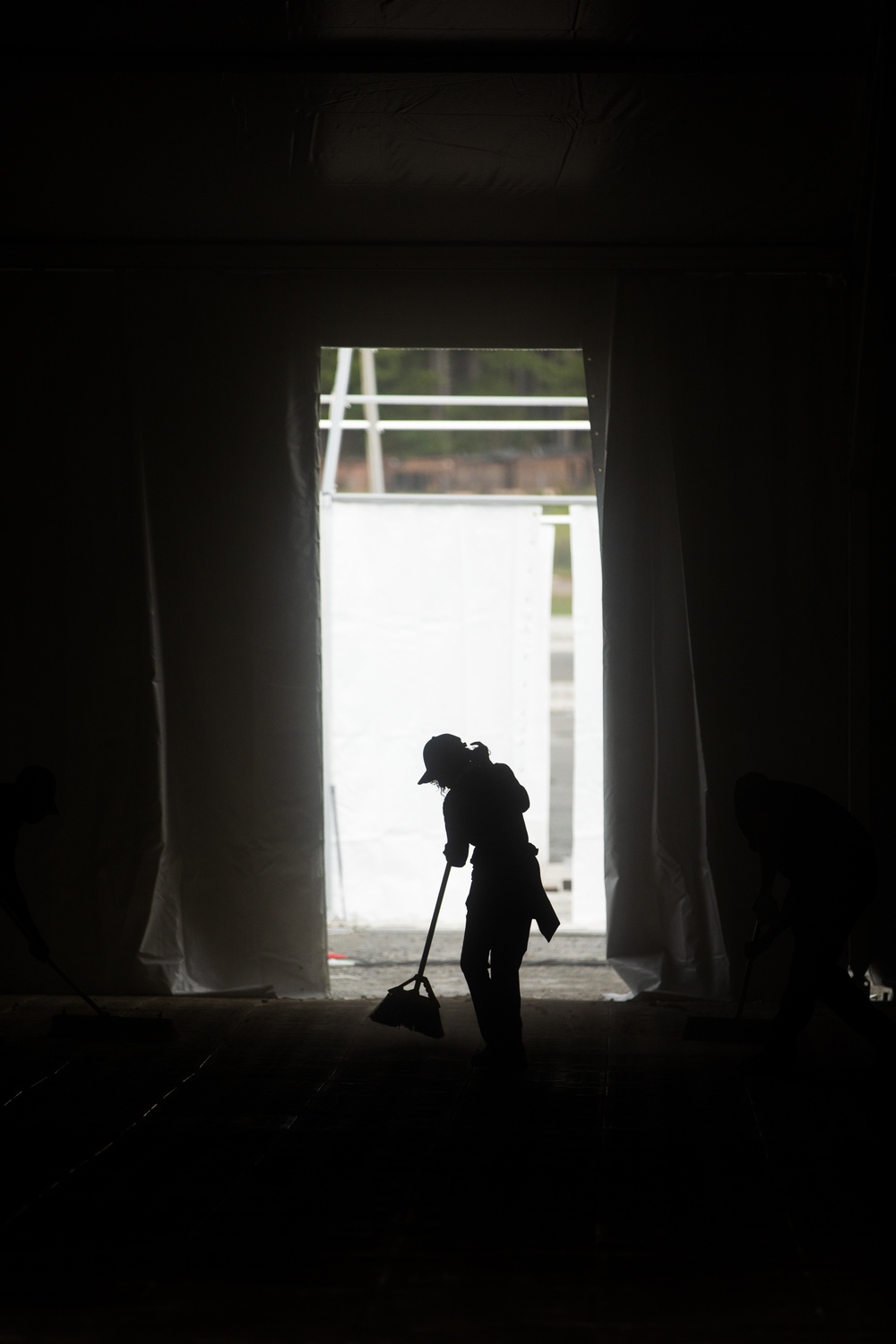 A Contract Worker Sweeps Newly Constructed Dining Facility at Fort Pickett, Virginia.