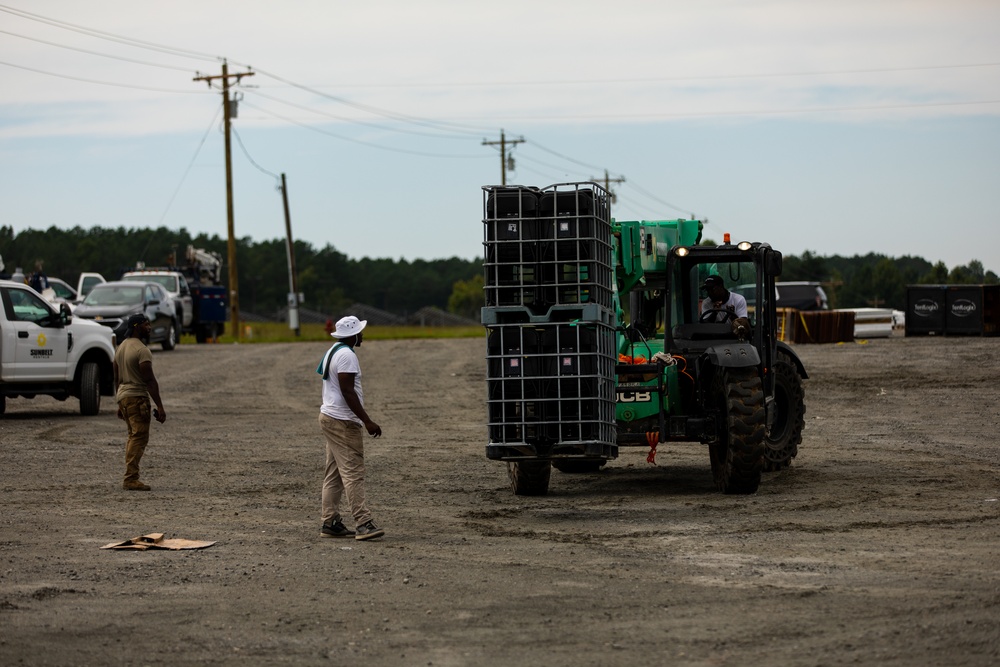 Contract Workers Moves Cases of Chairs into New Facilities for Afghan Personnel at Fort Pickett, Virginia.