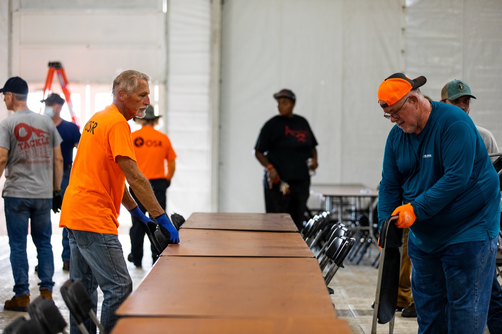 Contract Workers Sets Up Tables and Chairs in New Dining Facility for Afghan Personnel at Fort Pickett, Virginia.