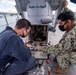 Sailors assigned to the forward deployed amphibious assault ship USS America perform maintenance on one of the ships radars.