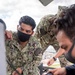 Sailors assigned to the forward deployed amphibious assault ship USS America perform maintenance on one of the ships radars.