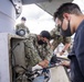 Sailors assigned to the forward deployed amphibious assault ship USS America perform maintenance on one of the ships radars.